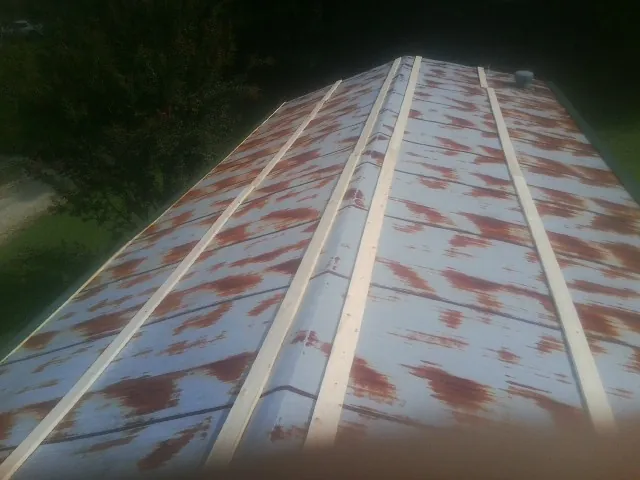 Rusted metal roof panels with new wood purlins before replacement — Storm Damage Roof Repair in Pauma Valley by Roofing Brothers