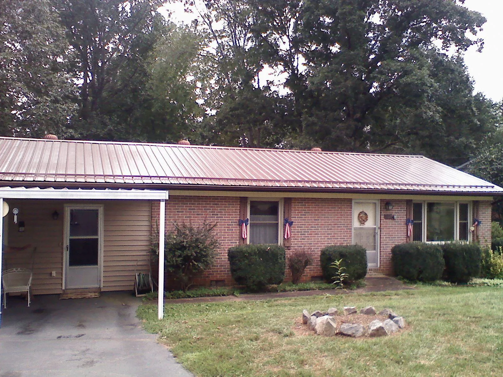 Bronze metal roof and carport on a brick ranch home — Roof Repair work by our crew in Pauma Valley